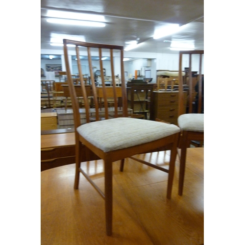 35 - A McIntosh teak extending dining table and eight chairs