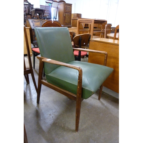 43 - A pair of teak and green vinyl armchairs