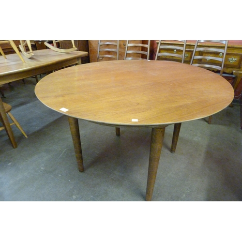 48 - A teak circular dining table