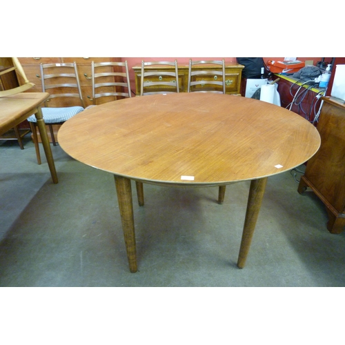 48 - A teak circular dining table