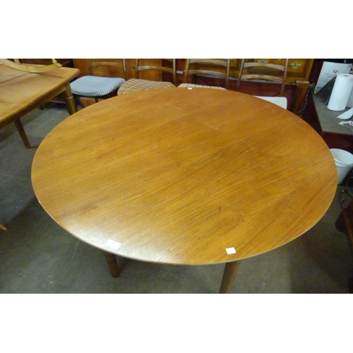 48 - A teak circular dining table