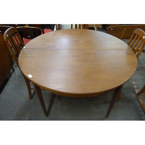 54 - A Sutcliffe of Todmorden S-Form teak extending dining table and four teak dining chairs