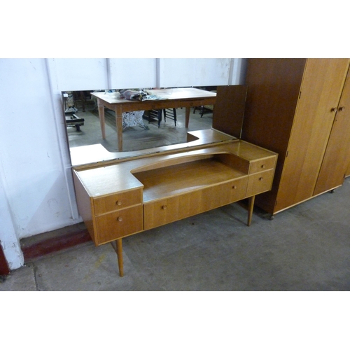 68 - A Meredew oak four piece bedroom suite, comprising; wardrobe, tallboy, dressing table and a chest of... 