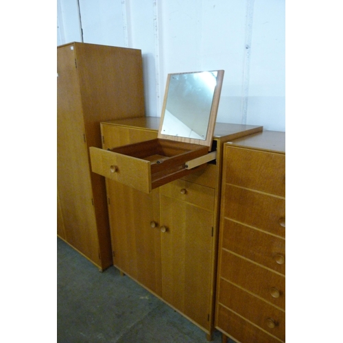 68 - A Meredew oak four piece bedroom suite, comprising; wardrobe, tallboy, dressing table and a chest of... 