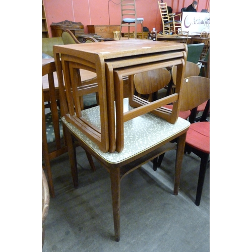 74 - A teak nest of tables and a tola wood and Formica topped occasional table