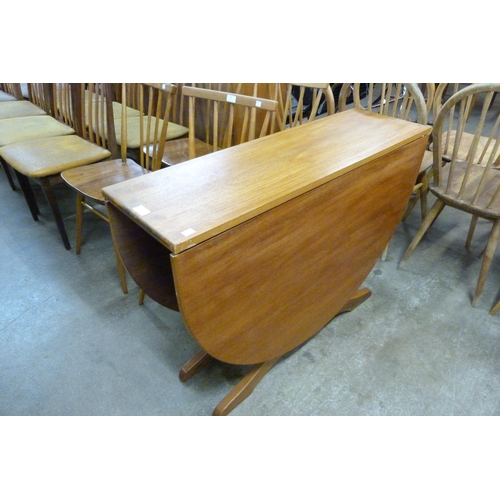 77 - A teak drop-leaf table