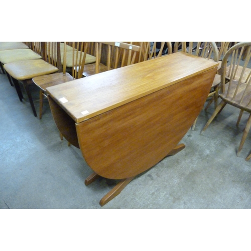 77 - A teak drop-leaf table