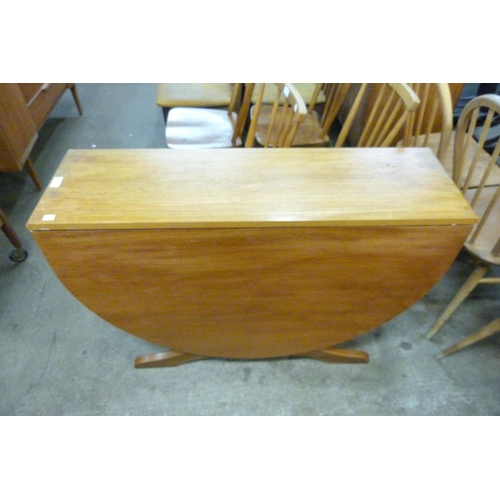 77 - A teak drop-leaf table