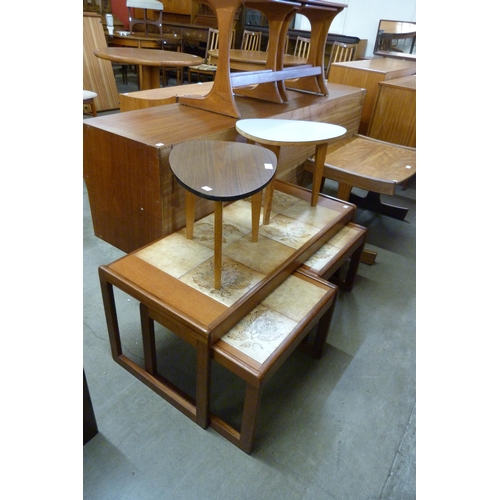 98 - A teak and tiled top nest of tables and a pair of Formica topped occasional tables