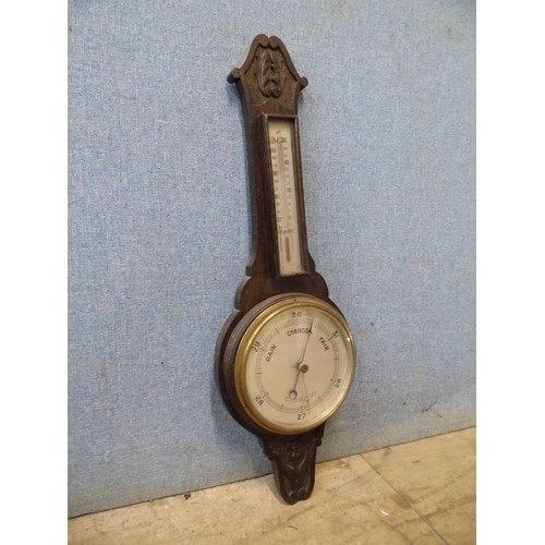 351A - An early 20th Century carved oak aneroid barometer