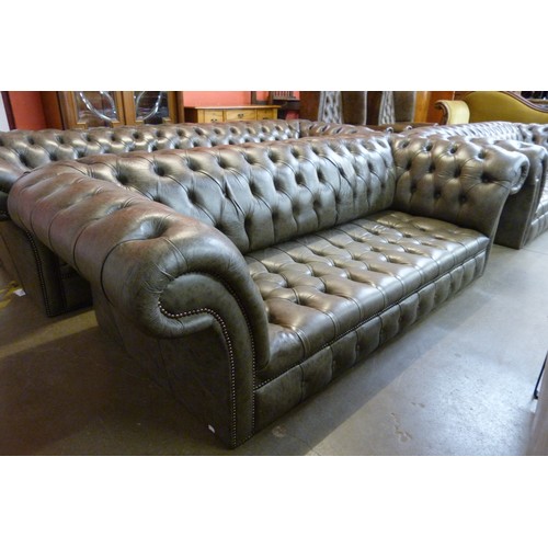 121 - A grey leather Chesterfield settee