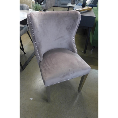 1301 - A grey ceramic top dining table with a set of six pink velvet dining chairs  *This lot is subject to... 