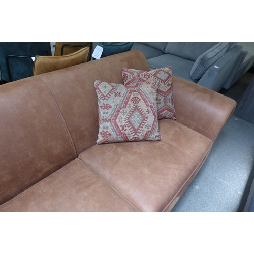 1485 - A tan vegan leather upholstered three seater sofa