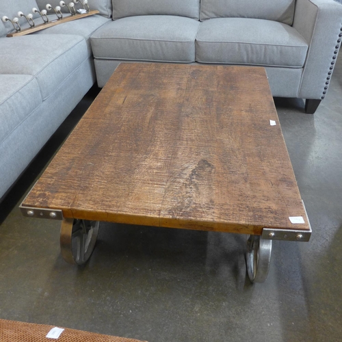 1500 - A hardwood industrial coffee table on wheels