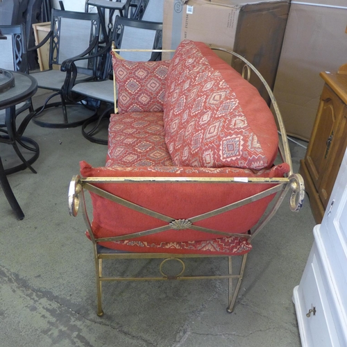 1568 - A gold painted metal and red upholstered 2.5 seater sofa