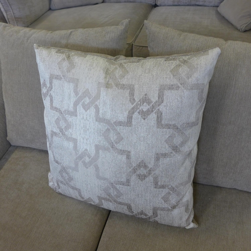 1586 - A small light grey two seater sofa with patterned scatter cushion