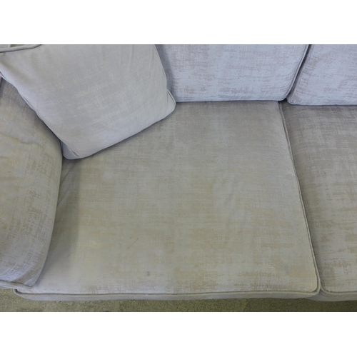 1587 - A pair of Barker And Stonehouse champagne three seater sofas - worn