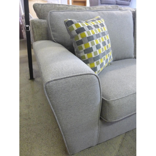 1601 - A grey upholstered three seater sofa with patterned scatter cushions