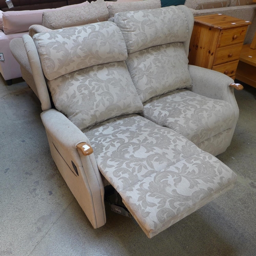 1602 - An olive green patterned two seater manual reclining sofa