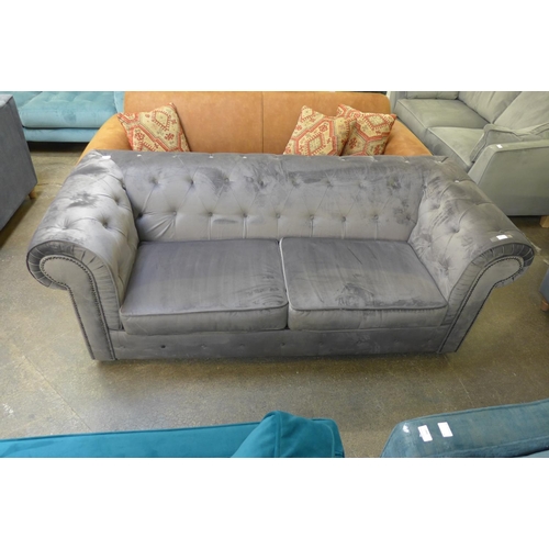 1484 - A grey velvet buttoned Chesterfield style three seater sofa