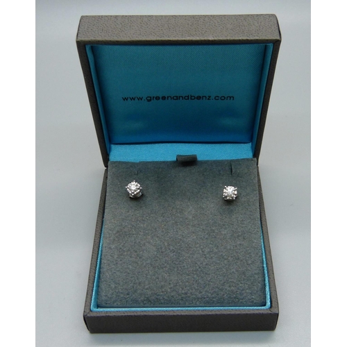 1021 - A pair of 14ct white gold and diamond stud earrings, 1g, (one butterfly fastener marked 375)