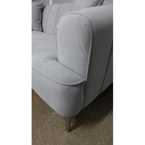 1422 - A grey velvet upholstered shell back two seater sofa