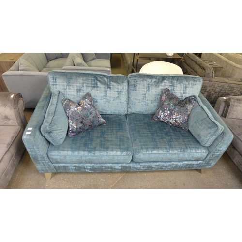 1460 - A Barker And Stonehouse teal velvet upholstered four seater sofa with patterned scatter cushions