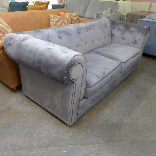 1484 - A grey velvet buttoned Chesterfield style three seater sofa