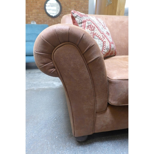 1485 - A tan vegan leather upholstered three seater sofa