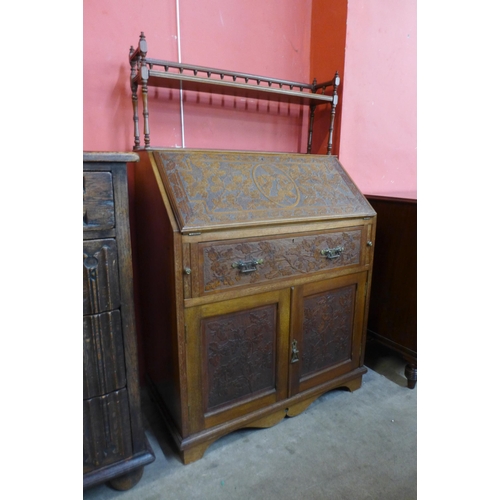 101 - A Victorian Aesthetic Movement carved walnut bureau