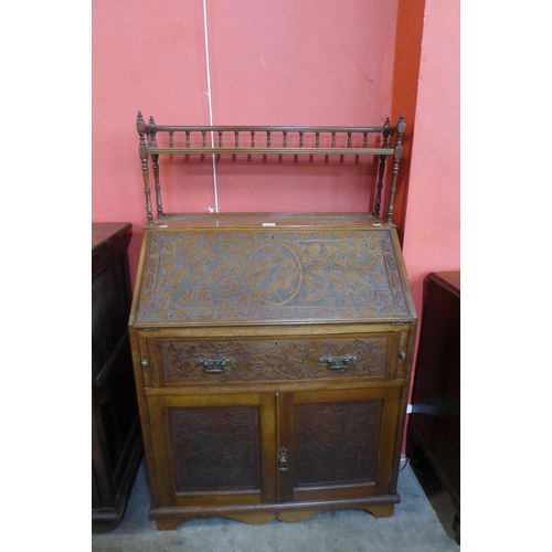 101 - A Victorian Aesthetic Movement carved walnut bureau