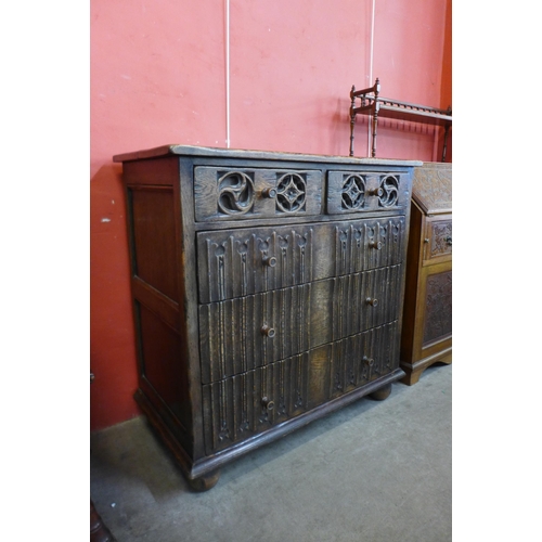 102 - An Elizabethan Revival carved oak linenfold chest of drawers