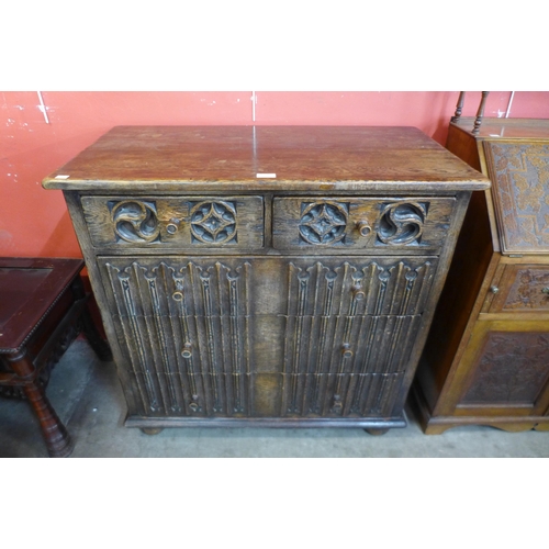 102 - An Elizabethan Revival carved oak linenfold chest of drawers