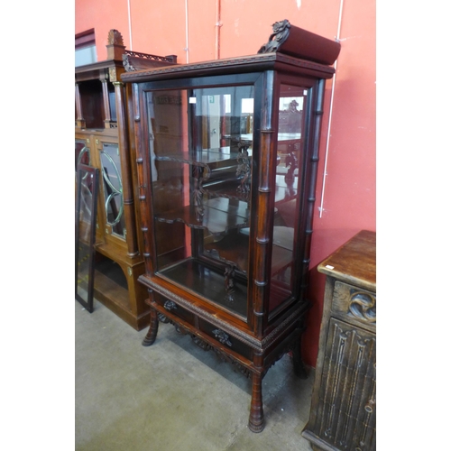 104 - A Chinese carved hardwood side cabinet