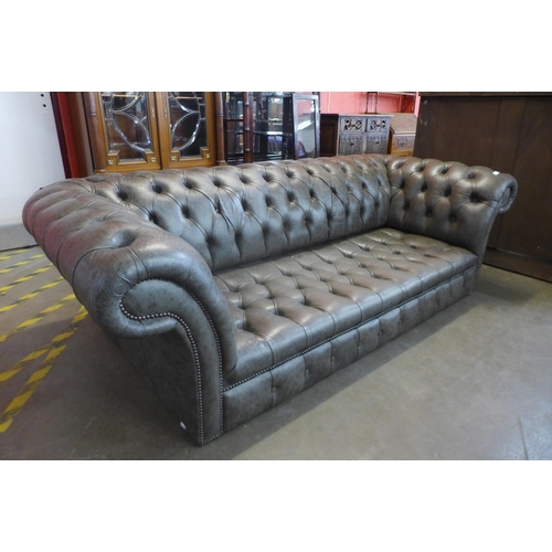 106 - A grey leather Chesterfield settee