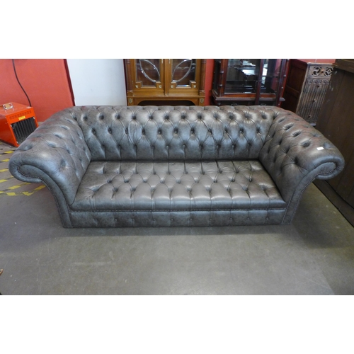 106 - A grey leather Chesterfield settee