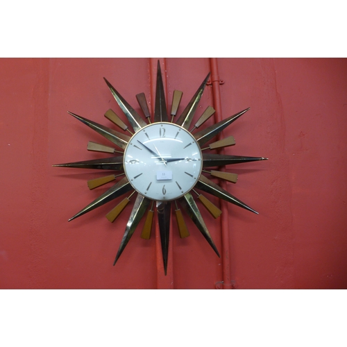 11 - A Metamec teak and brass sunburst wall clock