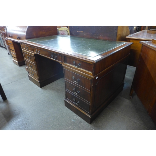 119 - A mahogany and green leather topped library desk