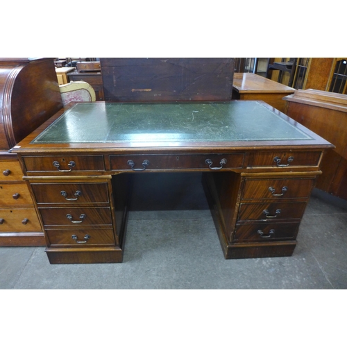 119 - A mahogany and green leather topped library desk