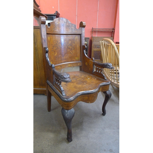 121A - A 19th Century Dutch inlaid walnut carved armchair