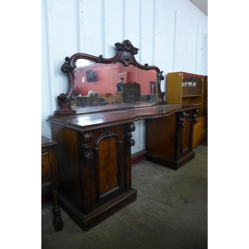 125 - A Victorian mahogany mirrorback pedestal sideboard