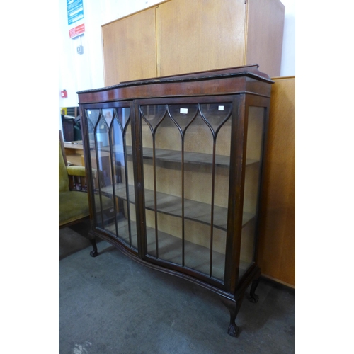 128 - A mahogany serpentine display cabinet