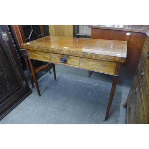 132 - A George III inlaid mahogany rectangular fold over games table