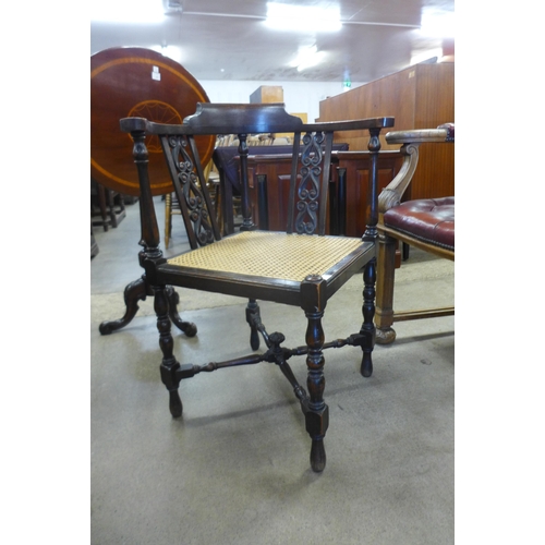 147 - An early 20th Century oak bergere corner chair