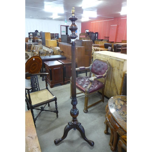 148 - An early 20th Century Hepplewhite Revival carved mahogany floor standing lamp