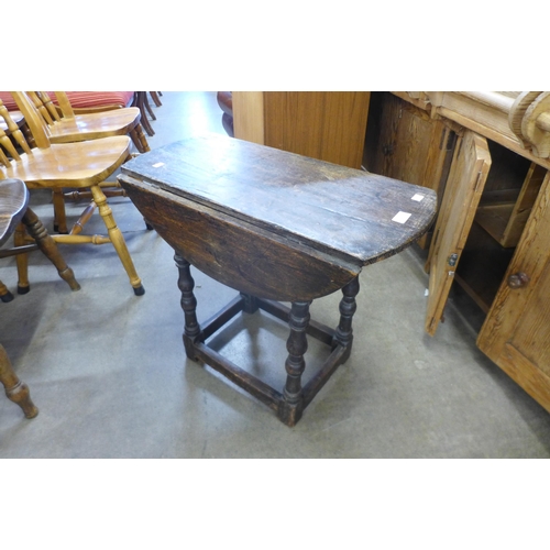 150 - A small 17th Century and later oak drop-leaf table