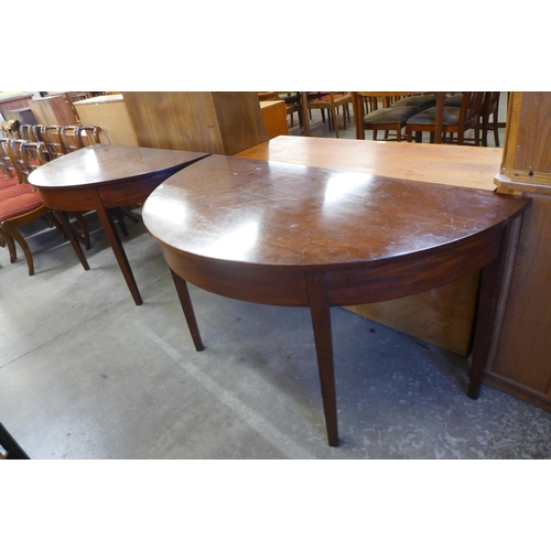 156 - A pair of George IV mahogany demi-lune console tables