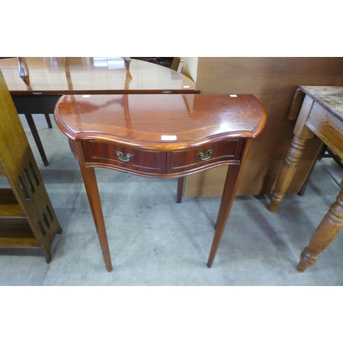 159 - A mahogany serpentine two drawer hall table