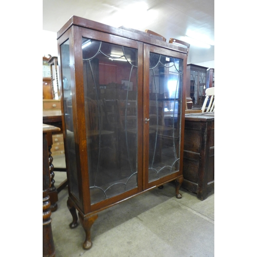 170 - An Art Deco oak two door display cabinet