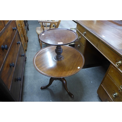 173 - A George III style mahogany circular revolving two tier dumb waiter